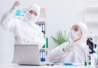 Two scientists working in the chemical lab