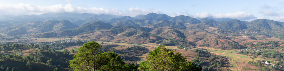 Fototapeta na wymiar Panorama of rolling hills and farm lands with rice fields in Shan state, Myanmar