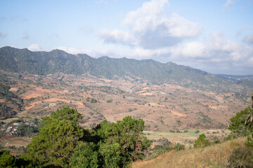 Fototapeta na wymiar Rolling hills and farm lands with rice fields in Shan state, Myanmar