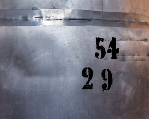black stencil numbers painted on a metal surface
