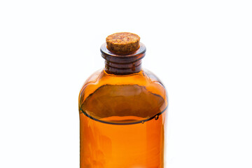 Brown bottle with essential oil on white