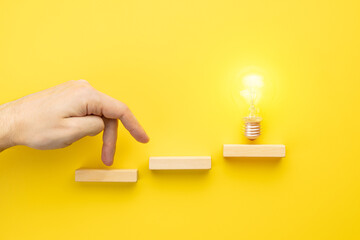 abstract business strategy concept. steps to idea symbol shown as light bulb over yellow background. inspiration and innovation conceptual