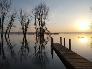 Dock at the launch site on river at early morning sunrise