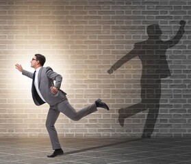 Businessman and his shadow in business concept