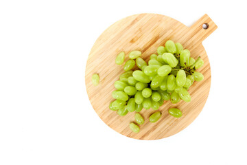 Green grapefruits a wooden cutting board