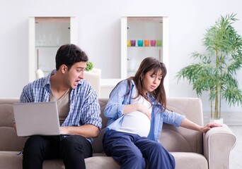 Pregnant woman with husband at home