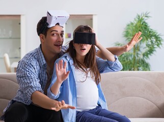 Young couple trying virtual reality glasses goggles