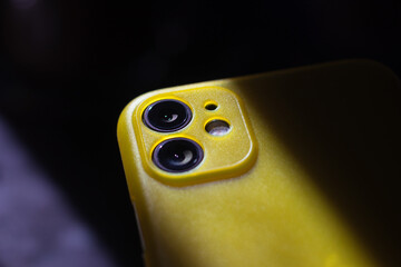 Close up of dual camera of smartphone illuminated by the rays of the sun