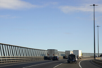 Heavy trucks & cars crossing West Gate Bridge.