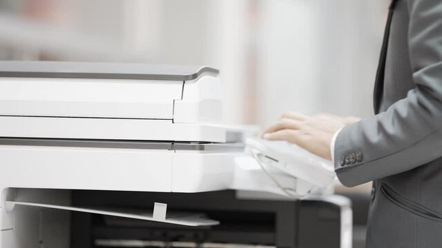Business men use copiers at the office