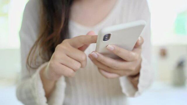 Woman trading bitcoin or crypto currency on mobile phone  Digital exchange, blockchain.
