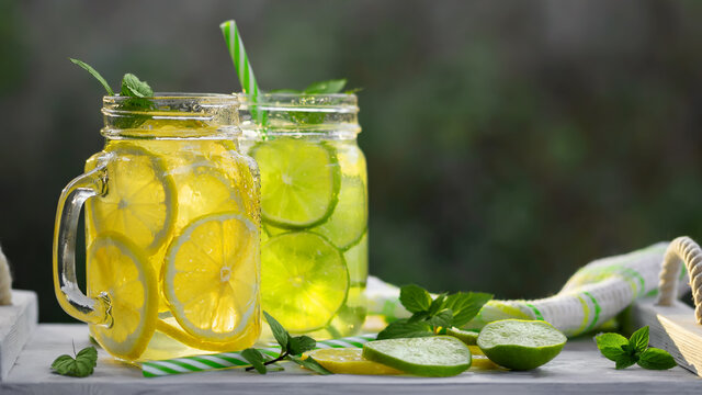 Cold refreshing homemade lemonade with mint, lemon and lime in mason jars