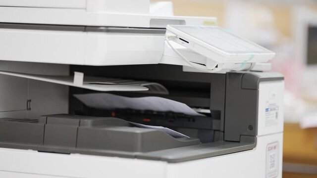 Business men use copiers at the office