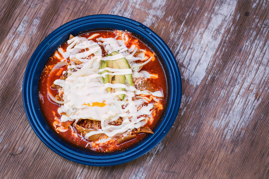 top view of red chilaquiles on a plate