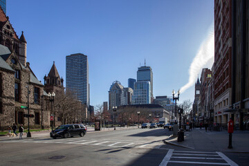 Boston, MA - April 8 2021: Back Bay neighborhood of Boston with office buildings and Trinity church. Center of Boston at Boylston Street.