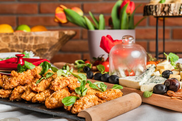 Fried chicken meat with sesame with basil on the plate on the table