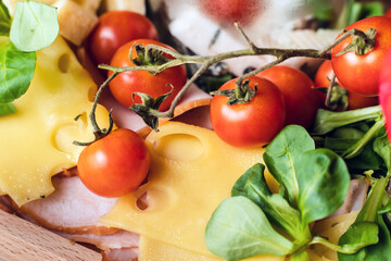 Close up on appetizer food on the table black olives and cheese top view