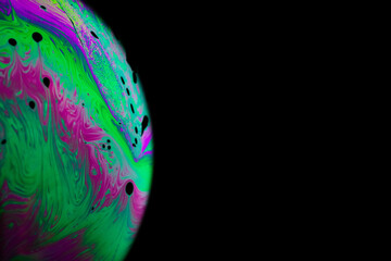Colourful bubbles. Abstract galaxy background with globe planet earth in universe space with sunlight on dark background. Abstract colorful soap bubble.