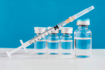 COVID-19 vaccine manufacturers. Coronavirus vaccine bottles with a syringe for injection. Immunization and treatment. Medicine vial. Healthcare and medical development concept.