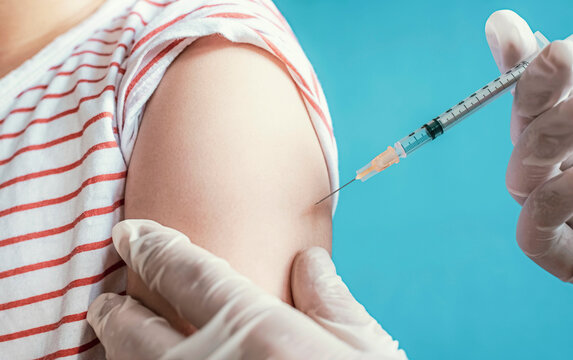 Kid receiving the vaccine. Clinical trials in young children for immunity against a disease. COVID-19 vaccination. Healthcare and medical treatment.