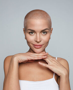 Close Up Portrait Of Cheerful Buzz Haircut Woman Isolated On Gray Background