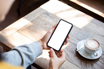 cell phone blank white screen mockup.woman hand holding texting using mobile on desk at office.background empty space for advertise.work people contact marketing business,technology