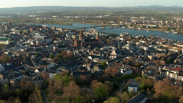 Mainz Drone Shot with the Cathedral church in the middle of old town with the blue Rhine river in the back