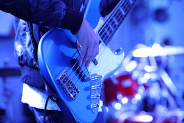 Naklejka premium close up hand of musician play guitar on stage, young musician playing guitar, live music background.