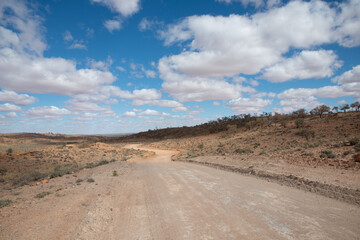 Australian rural landscape in a remote area of rural Outback. Dry harsh climate scenery with iconic red soil
