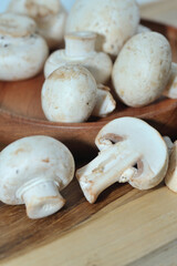 Mushrooms on a wooden chopping board on a white background