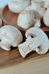 Mushrooms on a wooden chopping board on a white background