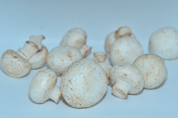 Mushrooms on a wooden chopping board on a white background