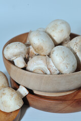 Mushrooms on a wooden chopping board on a white background