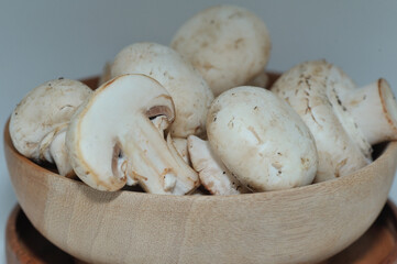 Mushrooms on a wooden chopping board on a white background