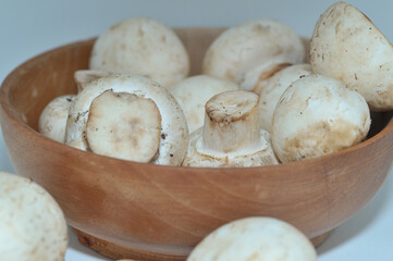Mushrooms on a wooden chopping board on a white background