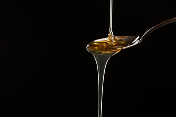 Pouring hemp oil into spoon.medical marijuana concept, CBD cannabis OIL, close up, Herbs for alternative medicine.