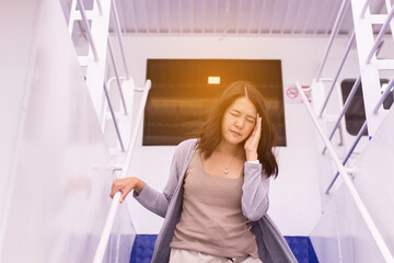 Woman suffering from sea sickness having motion sickness and feeling headache while on boat - obrazy, fototapety, plakaty