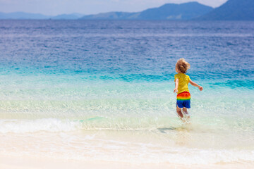 Fototapeta na wymiar Kids playing on beach. Children play at sea.