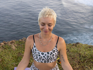 Portrait of woman with closed eyes. Short blond hair. Practicing meditation and pranayama breathing...