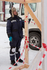 Worker assembling the frame of a wooden slide