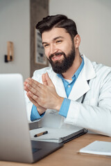 Smiling young caucasian grateful doctor using telehealth medical service