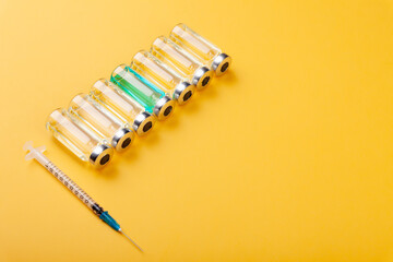 Glass vaccine ampoules, bottles, syringes, medicines, top view