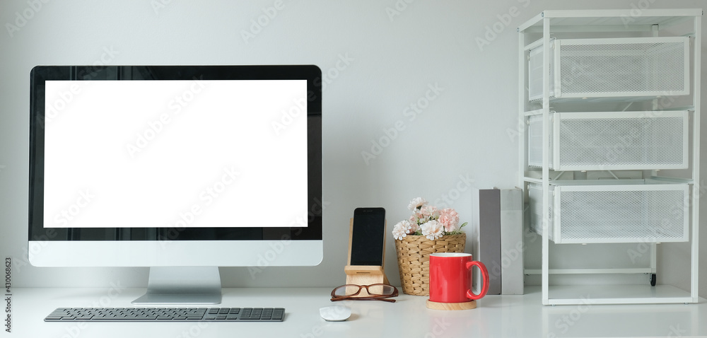 Poster modern workspace with computer with blank screen and equipment on white table.blank screen for your 