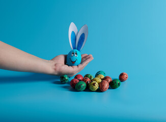 on the palm of your hand an egg with ears and Easter eggs