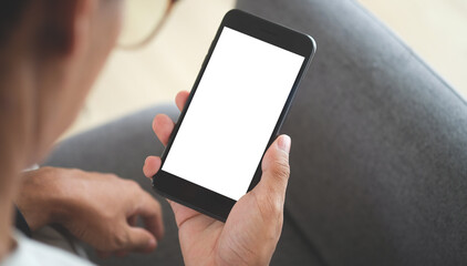 Close up view of business holding mobile phone with blank screen.	