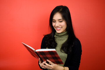 Young beautiful asian women using black sweater with red isolated background