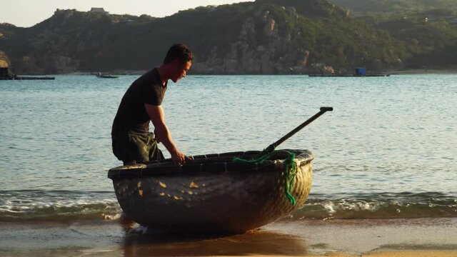 Fisherman takes coracle boat to go fishing, beach of Vinh Hy Bay, Vietnam