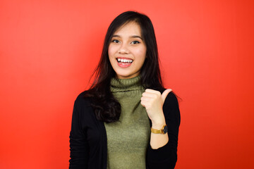 Young beautiful asian women using black sweater with red isolated background