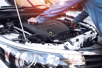 Close up view of men mechanic checking automobile machine in outdoor, maintenance service concept.