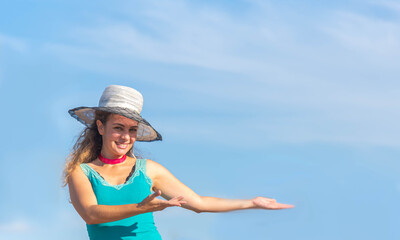 Brazilian woman in hat showing blue sky